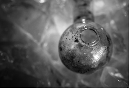 A zoomed-in black and white image of a used methamphetamine pipe